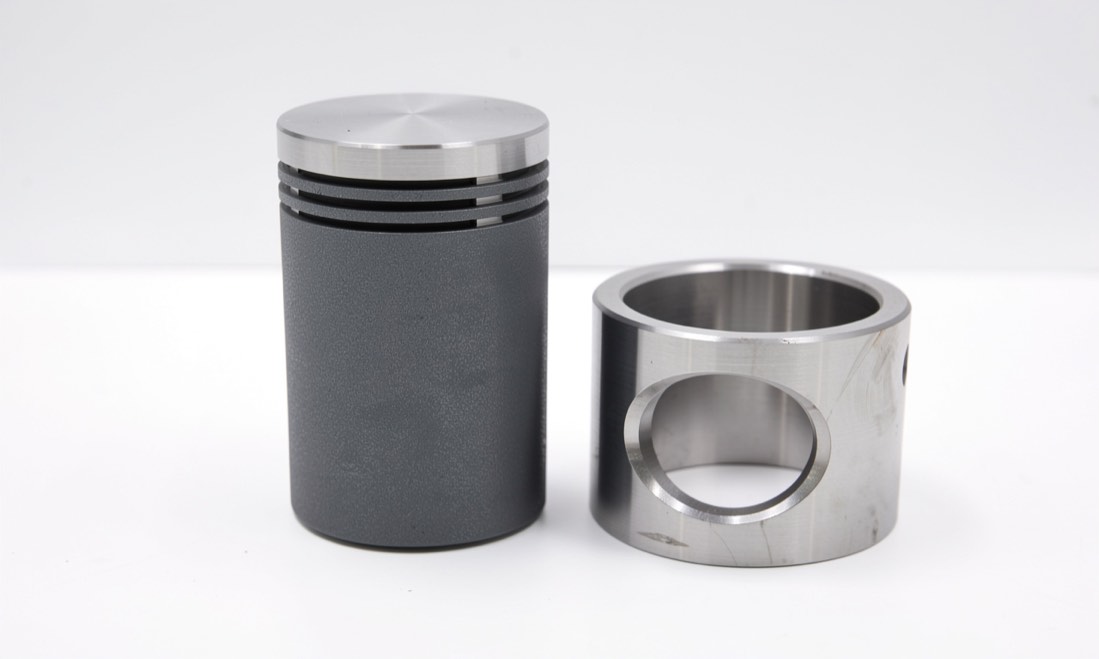 Grey low friction coated piston and cylinder sleeve on a clean bench